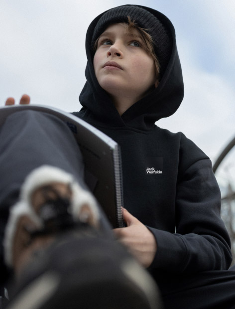 Boy with notepad and hoodie