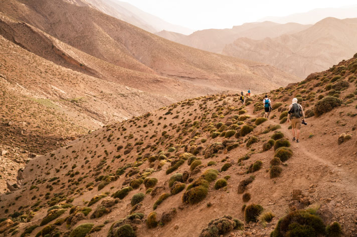 A group hiking through harsh mountain landscape